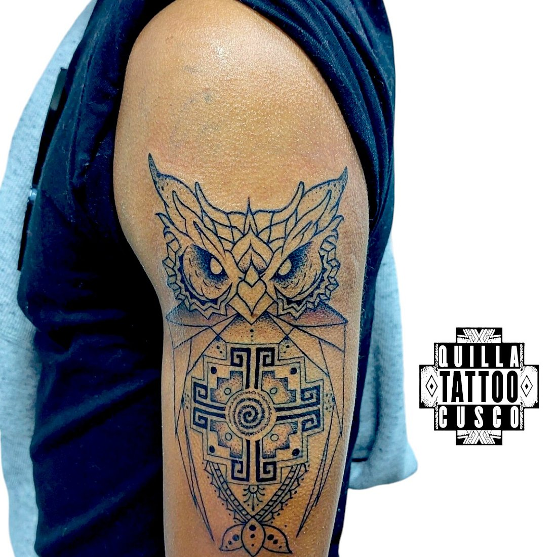 Geometric owl tattoo with Inca-inspired patterns on upper arm by Quilla Tattoo
